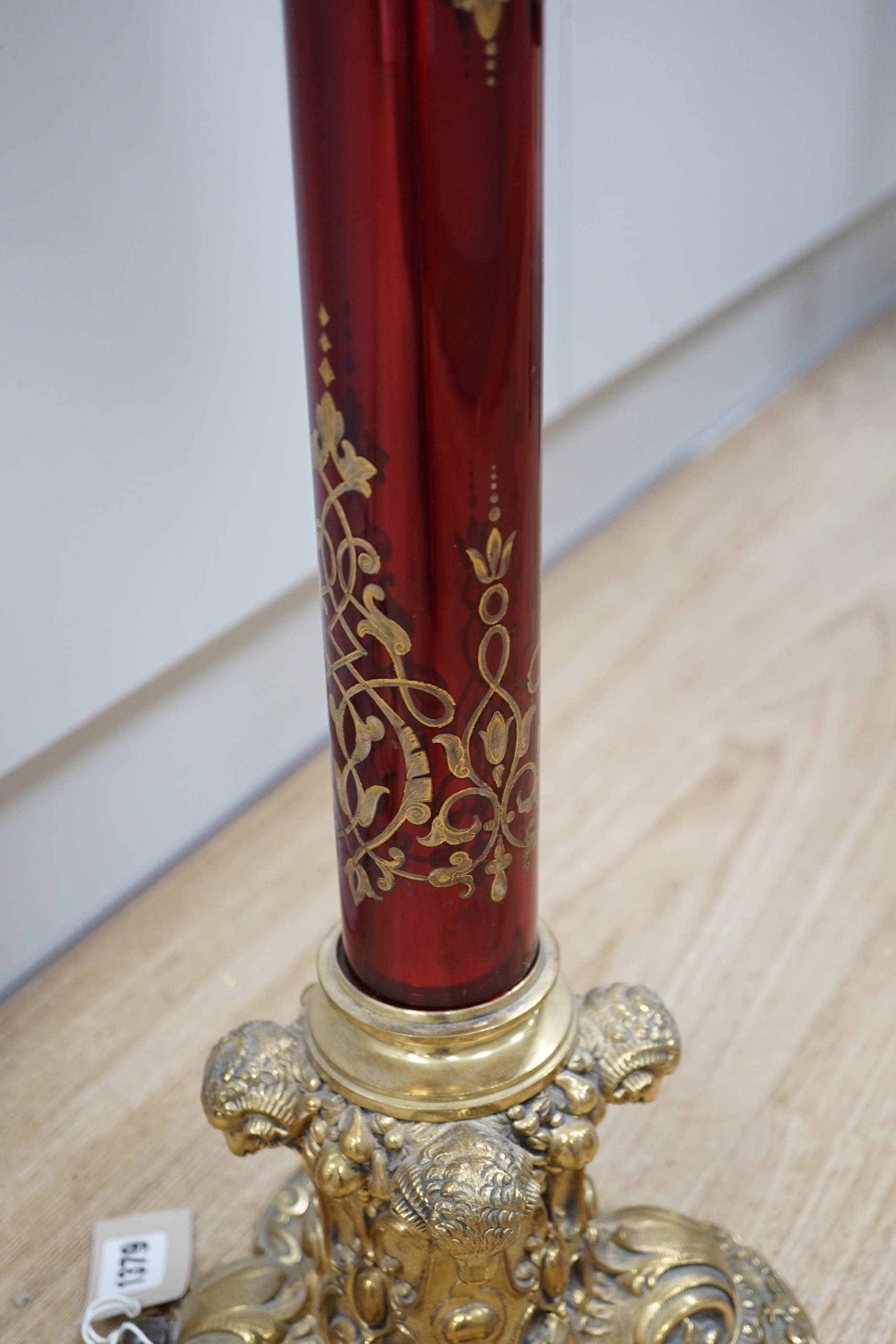 A Victorian style brass and ruby glass table lamp with shade, 81cm